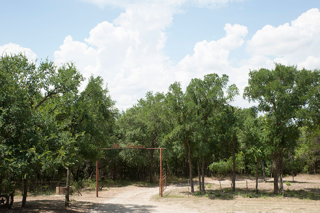 Farm entrance with trees and blue sky