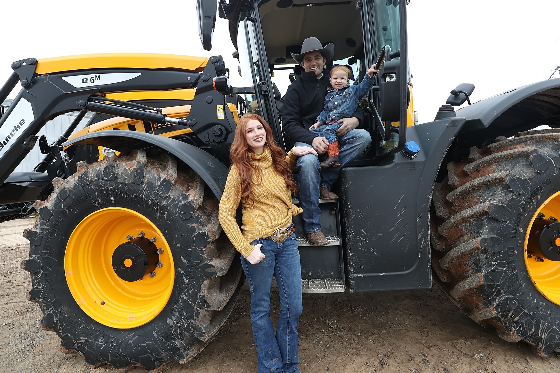 AgTrust Farm Credit customers, Hamish and Courtney Harley with daughter on tractor.
