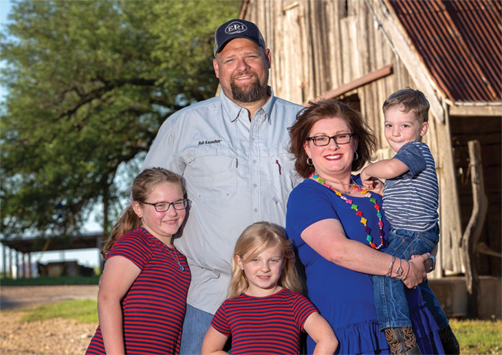 A family standing by the barn. AgTrust Farm Credit finances your place in the country.