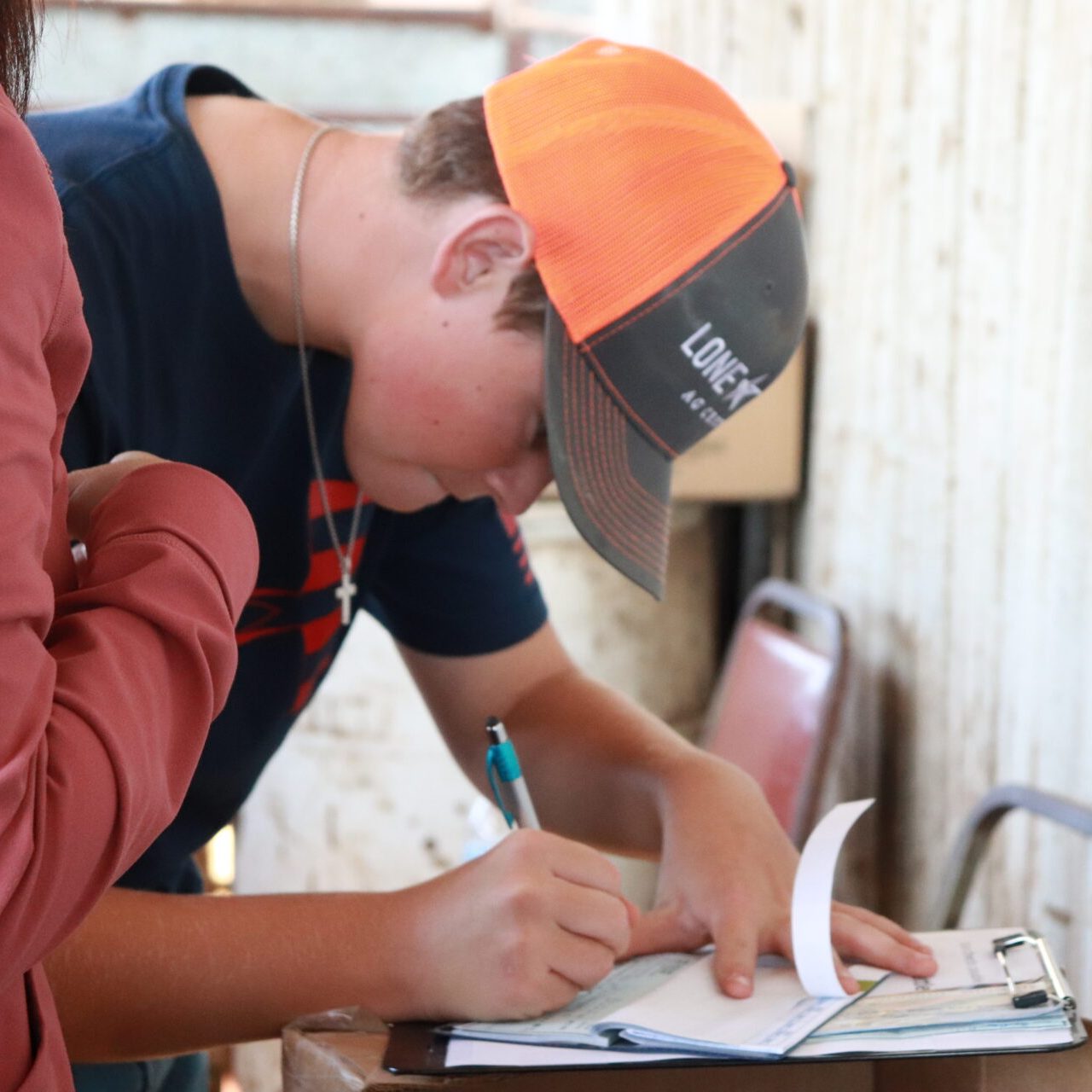 Pasture to Packer participant writing check to purchase project.
