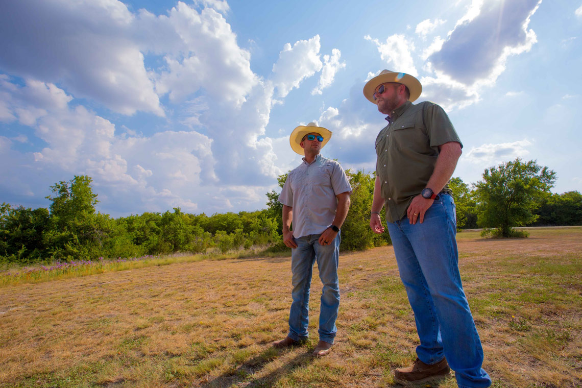 Outdoor image of two farmers.